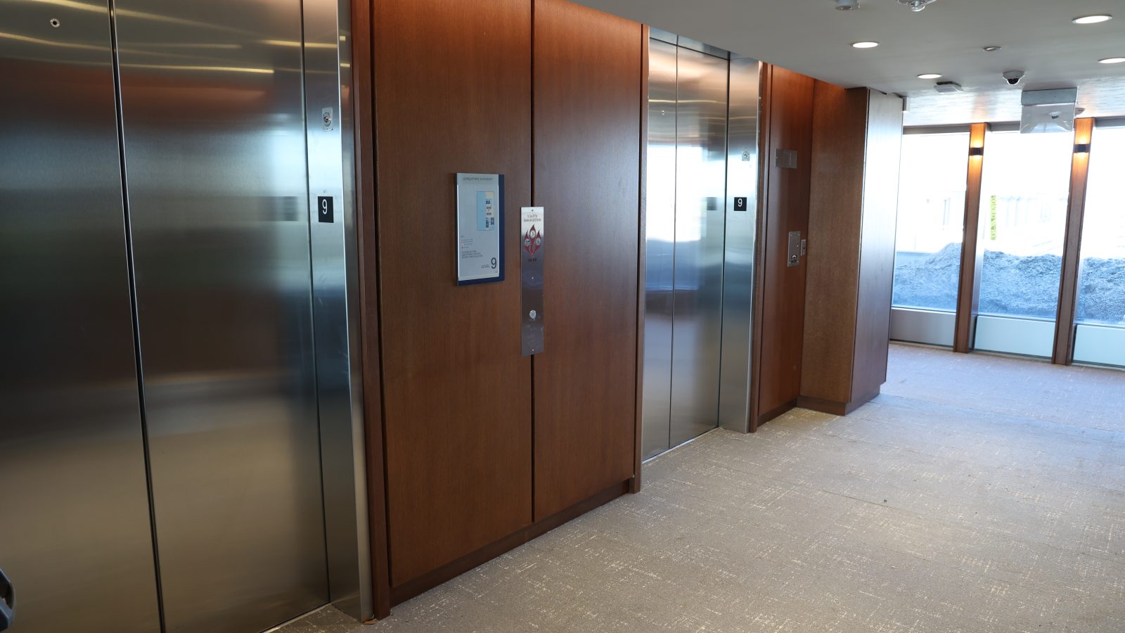 elevator bank with wood paneling in 125 E St