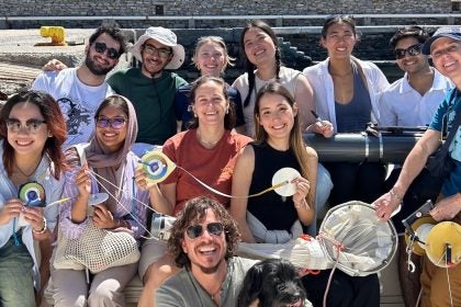 students and faculty group photo, holding measuring instruments