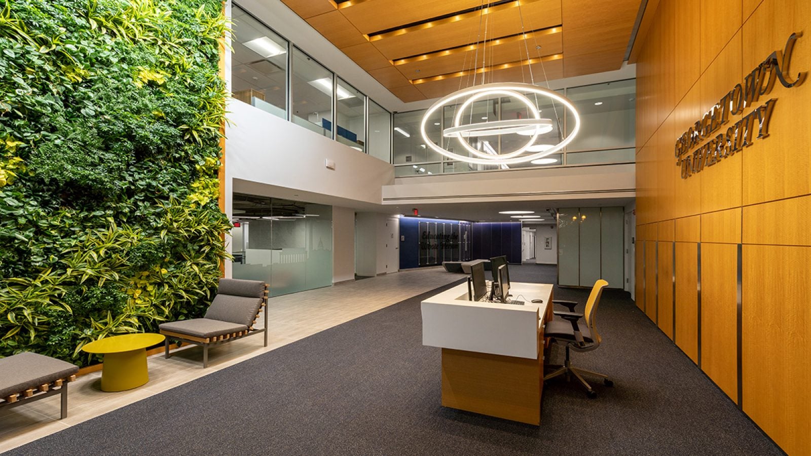 500 First Street lobby featuring a green plant wall and modern chandelier.