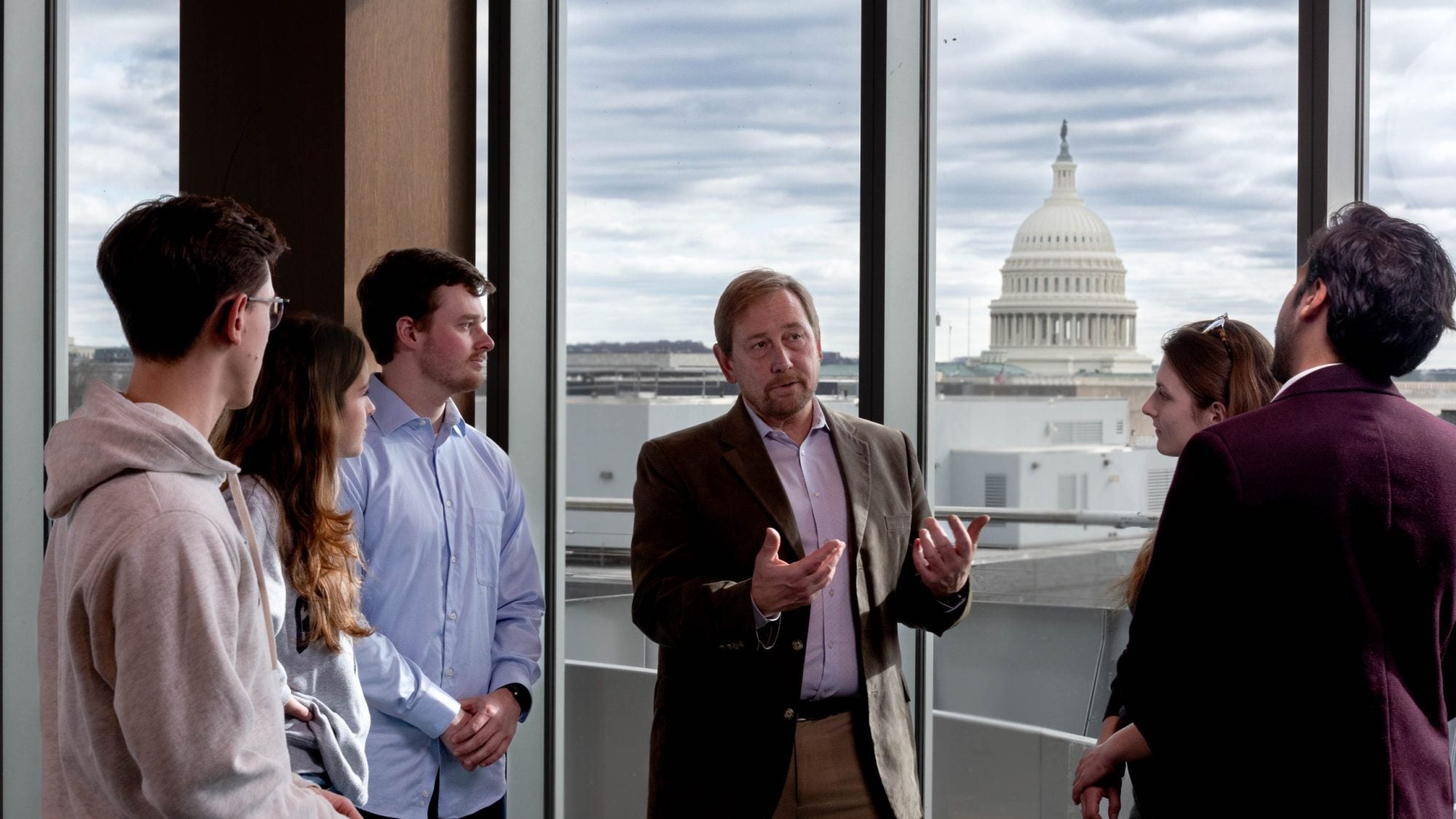 Professor talks to students with Capitol in Background